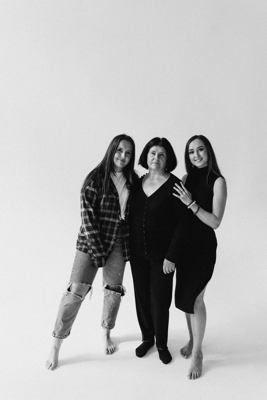 Black and white studio portrait of three women from one family
