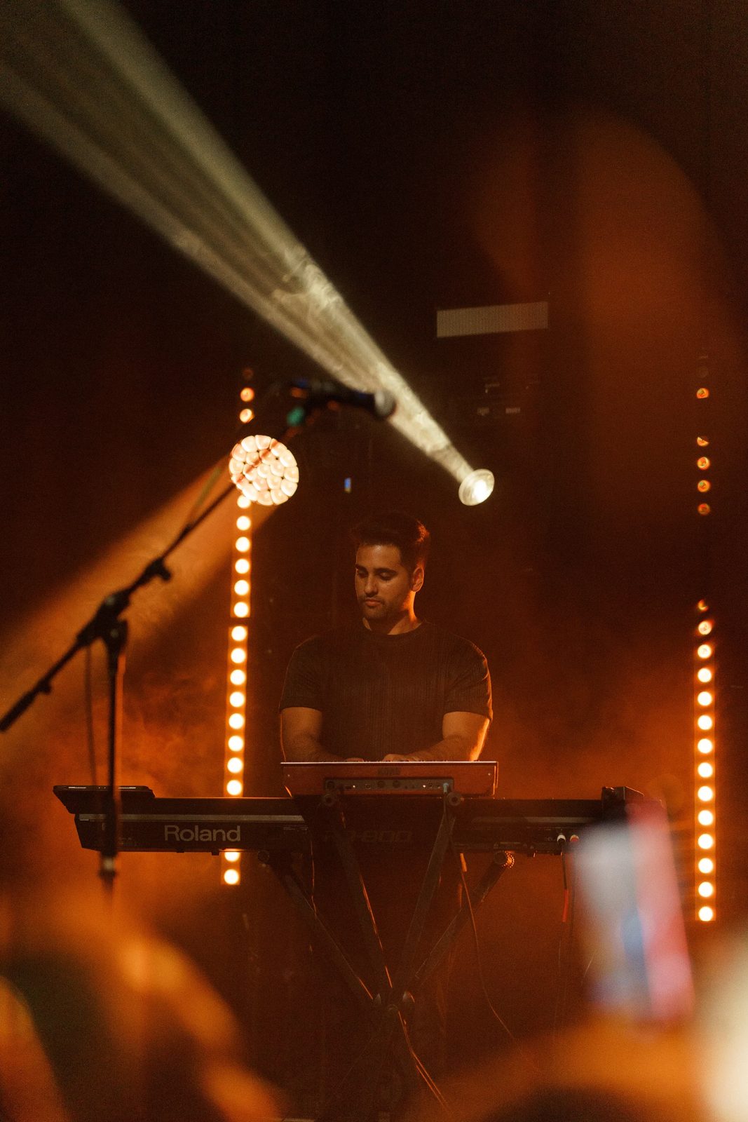 Keyboardist under a beam of stage light